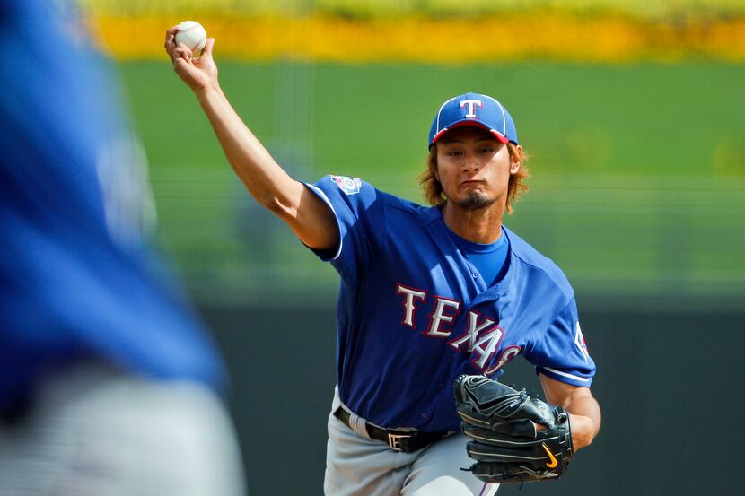 Mar 5, 2015; Surprise, AZ, USA; Texas Rangers pitcher Yu Darvish (11) throws a pitch in the...