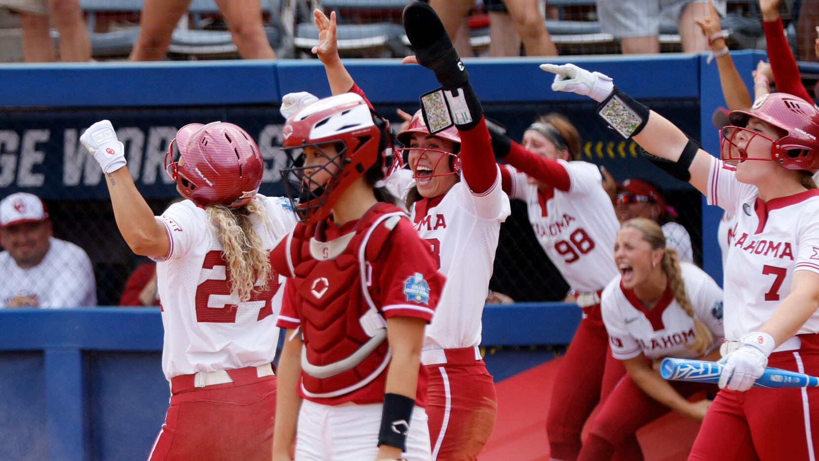 Stanford catcher Aly Kaneshiro, front right, stands in front of Oklahoma players as they...