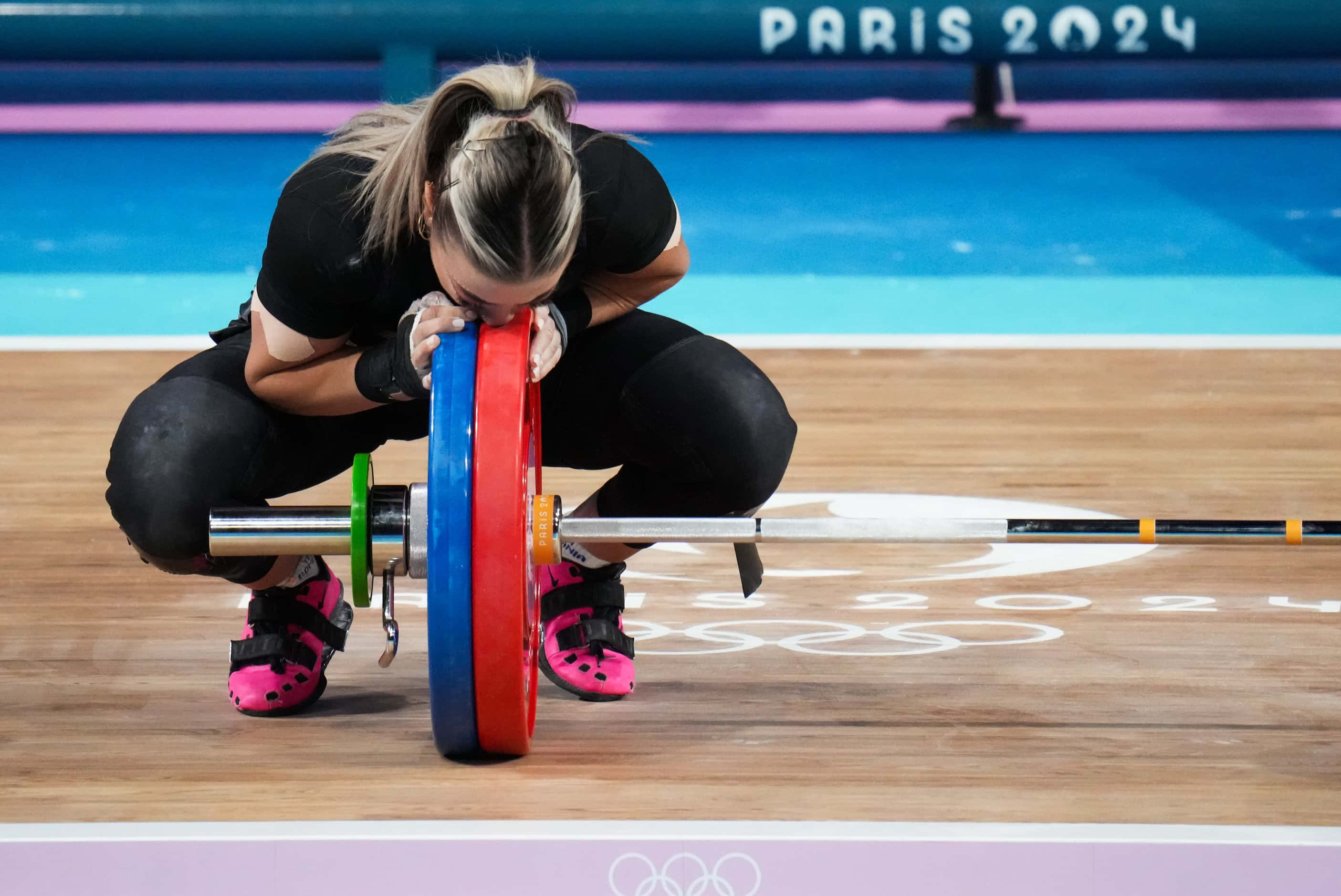 Mihaela Cambei of Romania reacts after lifting 112kg in the in the clean and jerk during...