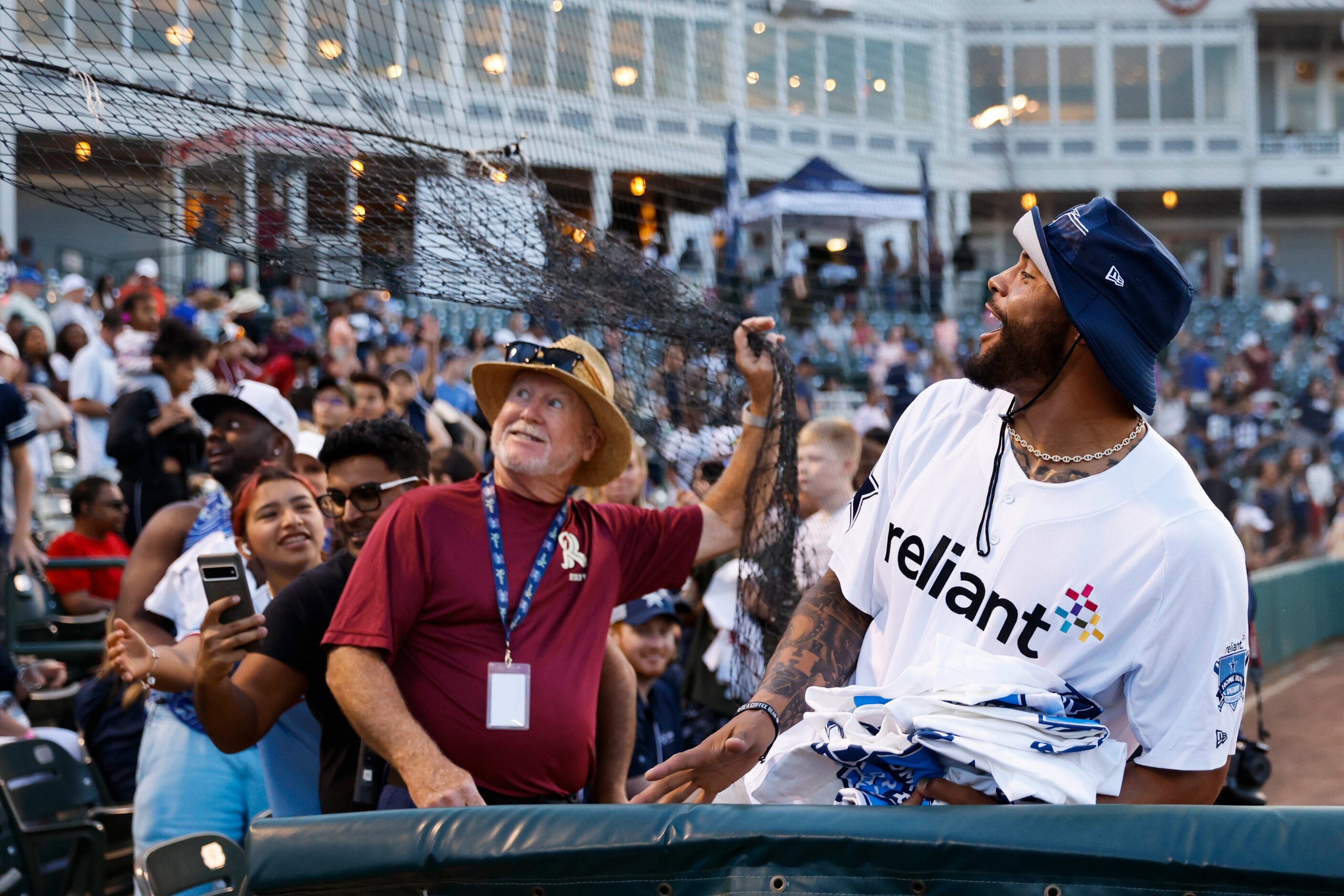 Dallas Cowboys QB Dak Prescott reacts as he throws t-shirts to fans during the annual home...