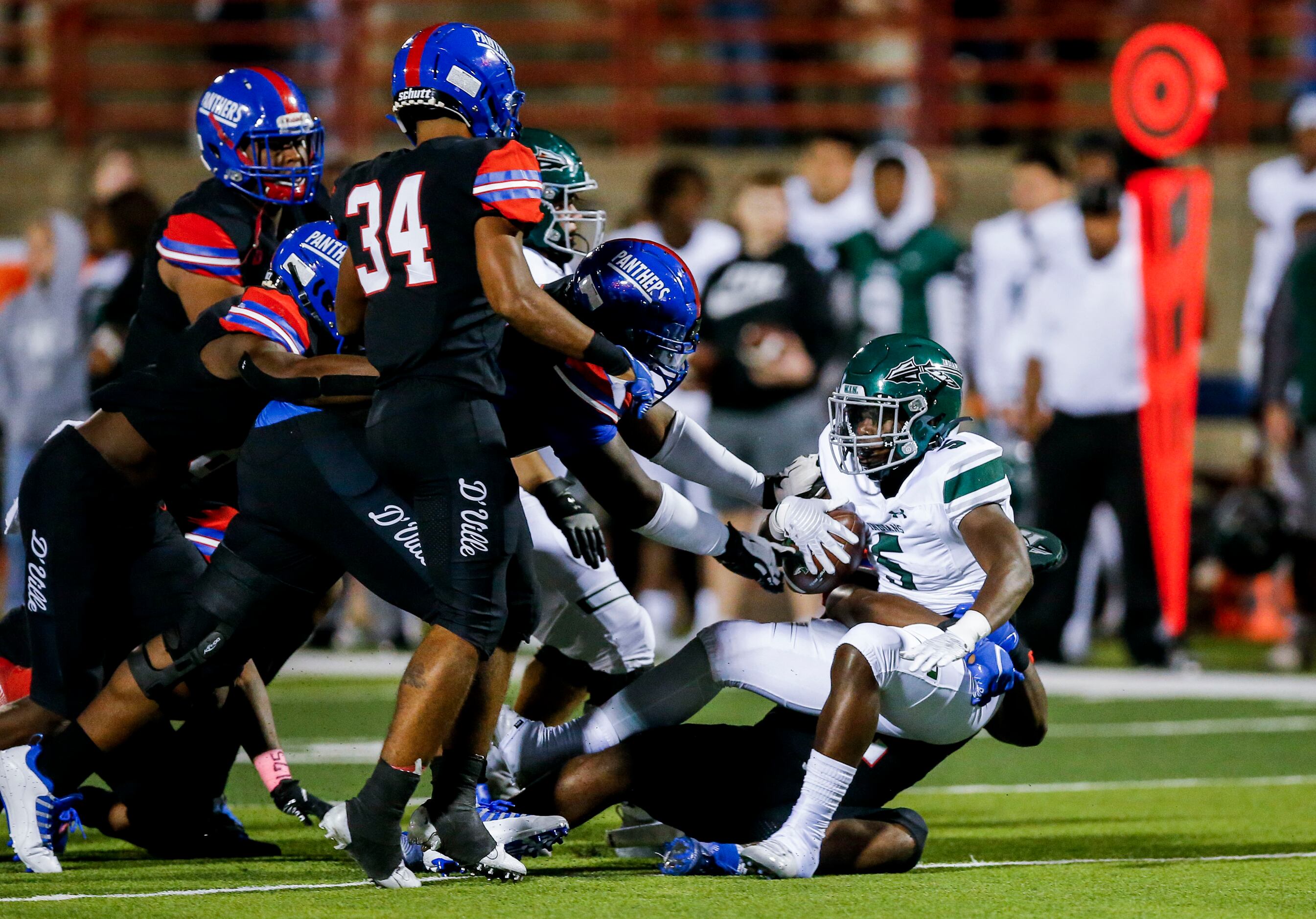Waxahachie junior running back Jayden Becks (5) is tackled by the Duncanville defense during...