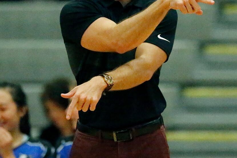 Plano West coach Justin Waters gives instruction to players on the floor during a match...