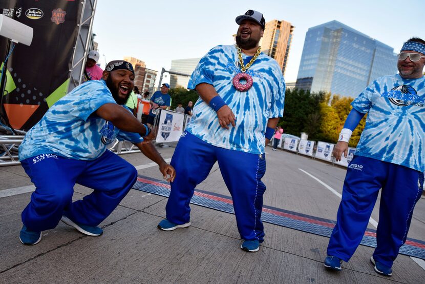 Munchie, left, and Osito, right, of the MavsManiacs dance to the music of a DJ before the...