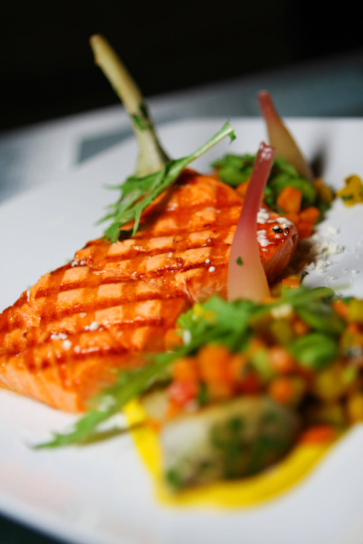 At Driftwood in Oak Cliff, grilled Copper River salmon is paired with a long- stemmed...