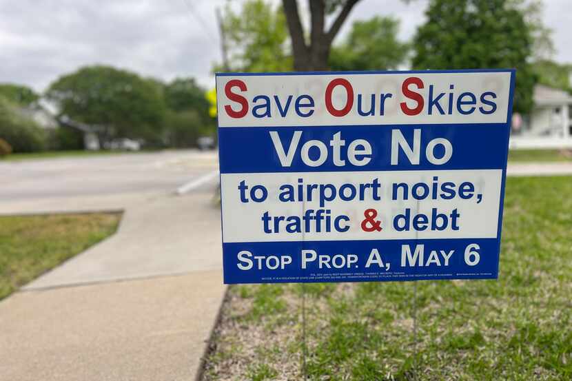 Signs along West Louisiana Street in McKinney urge people to vote against McKinney National...