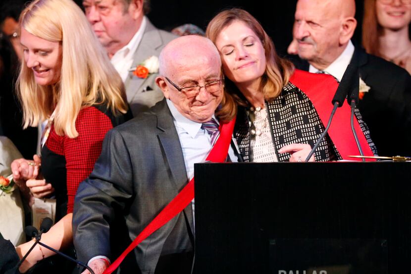 President and CEO Mary Pat Higgins hugs Holocaust survivor Max Glauben after cutting a...