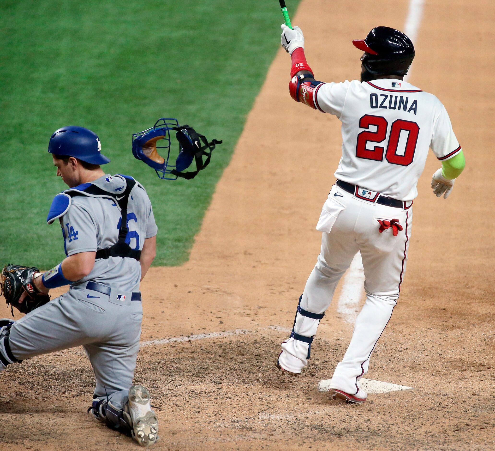 Atlanta Braves designated hitter Marcell Ozuna (20) knocks the mask off of Los Angeles...