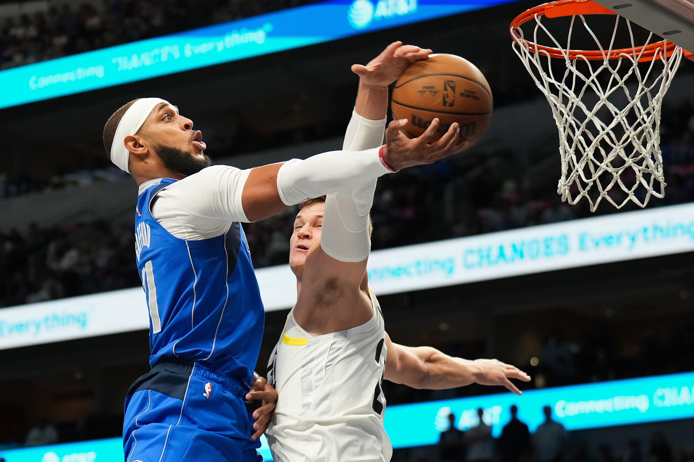 Dallas Mavericks center Daniel Gafford (21) is fouled by Utah Jazz center Walker Kessler...