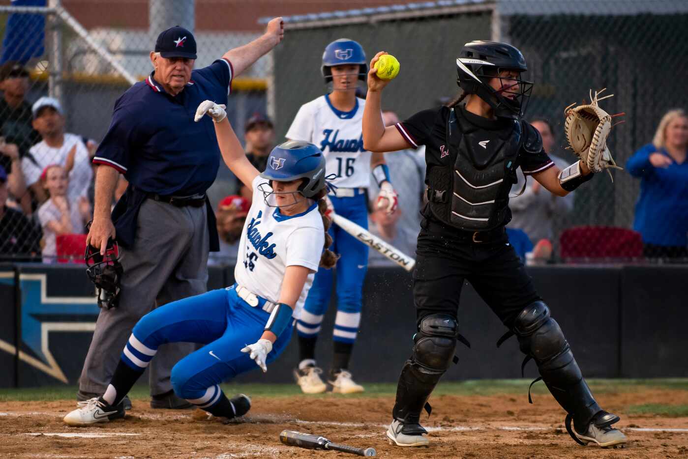Hebron catcher Zoe Bowen (15) slides in to score a run during the District 6-6A title game...