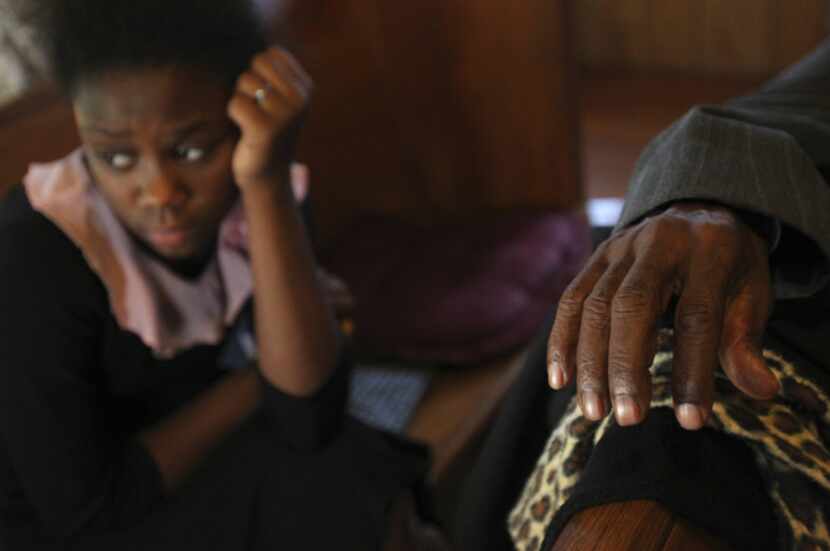 Willie Chapple taps his fingers to the music during an afternoon worship service, as Brianna...