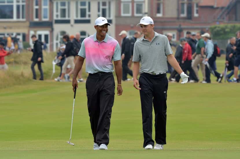 US golfer Jordan Spieth (L) and US golfer Tiger Woods share a joke on the 3rd green during...