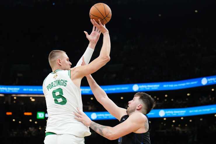 Boston Celtics center Kristaps Porzingis (8) shoots over Dallas Mavericks guard Luka Doncic...