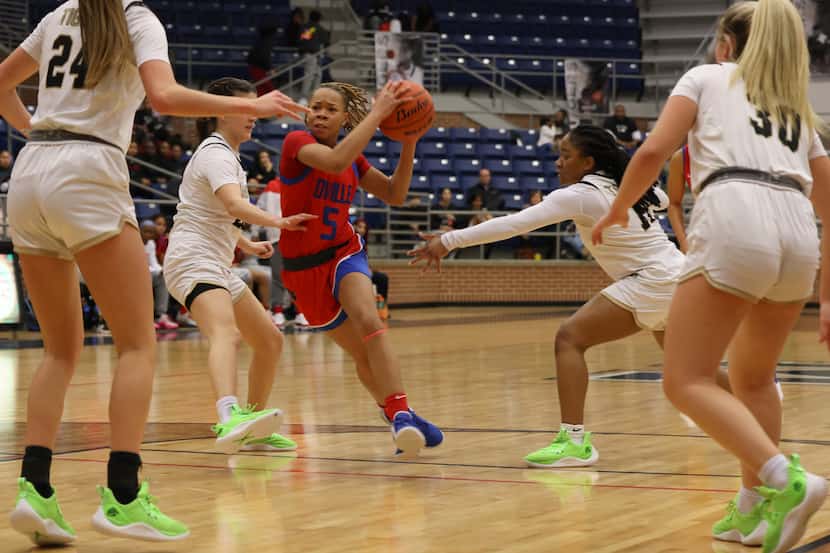 Duncanville guard Laila Coleman (5) drives the lane as she is defended by Mansfield...