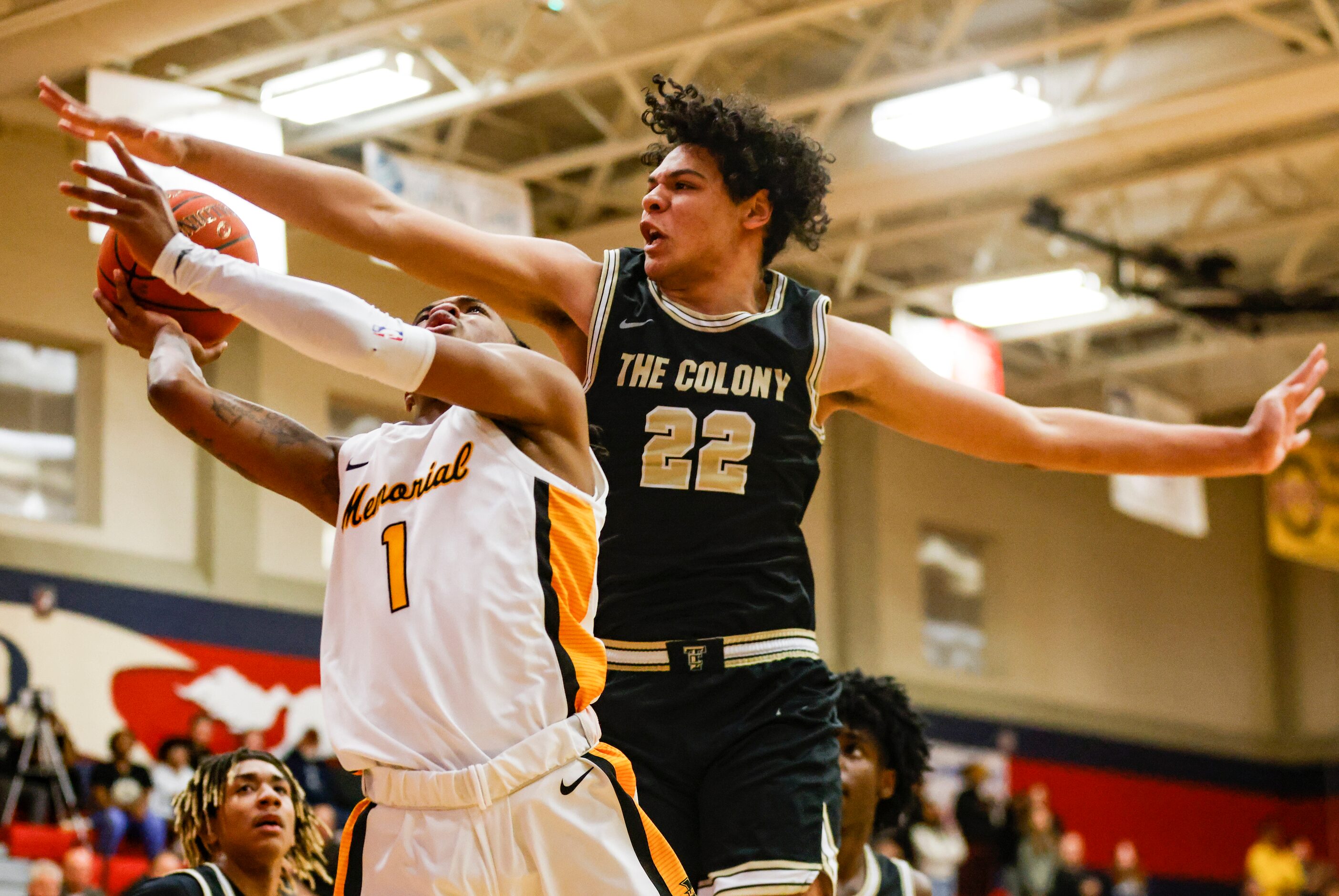 Memorial High School Isaiah Foster (1) jumps to shoot the ball as The Colony High School...