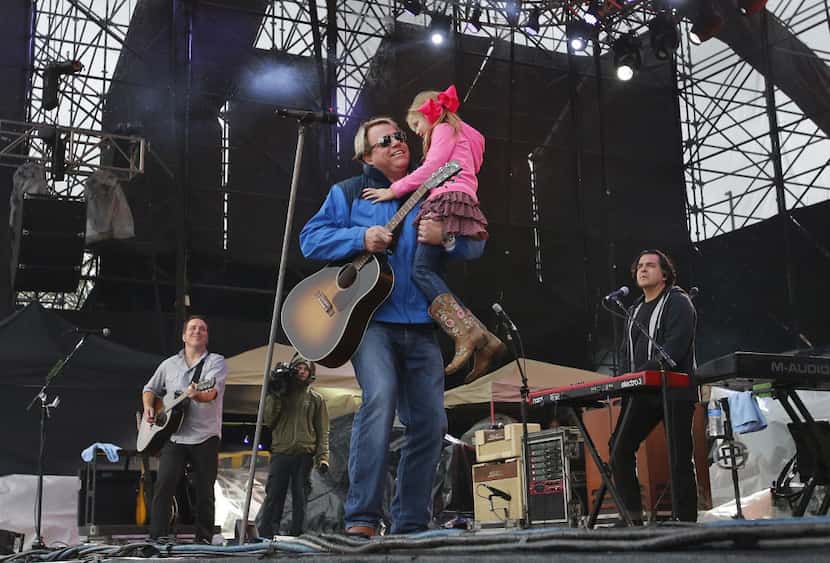 Pat Green brings his daughter on stage as he performs during the March Madness Music...