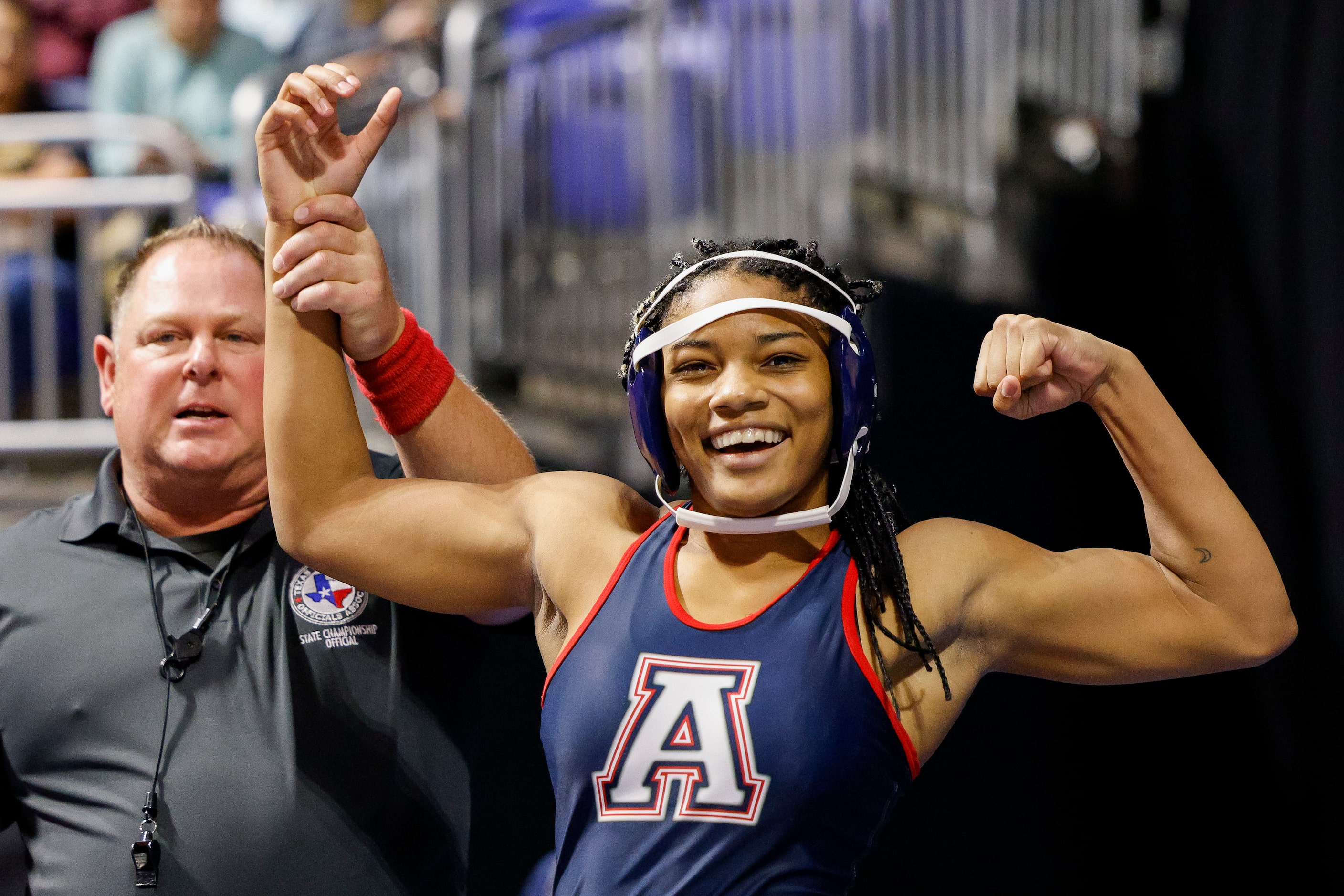 Jasmine Robinson of Allen flexes after winning a quarterfinal match of the 6A girls...