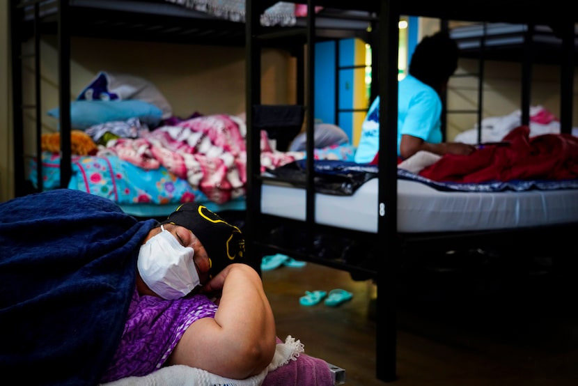 L.A. White wore a face mask as she rested in a bunk at Austin Street Center on March 11,...