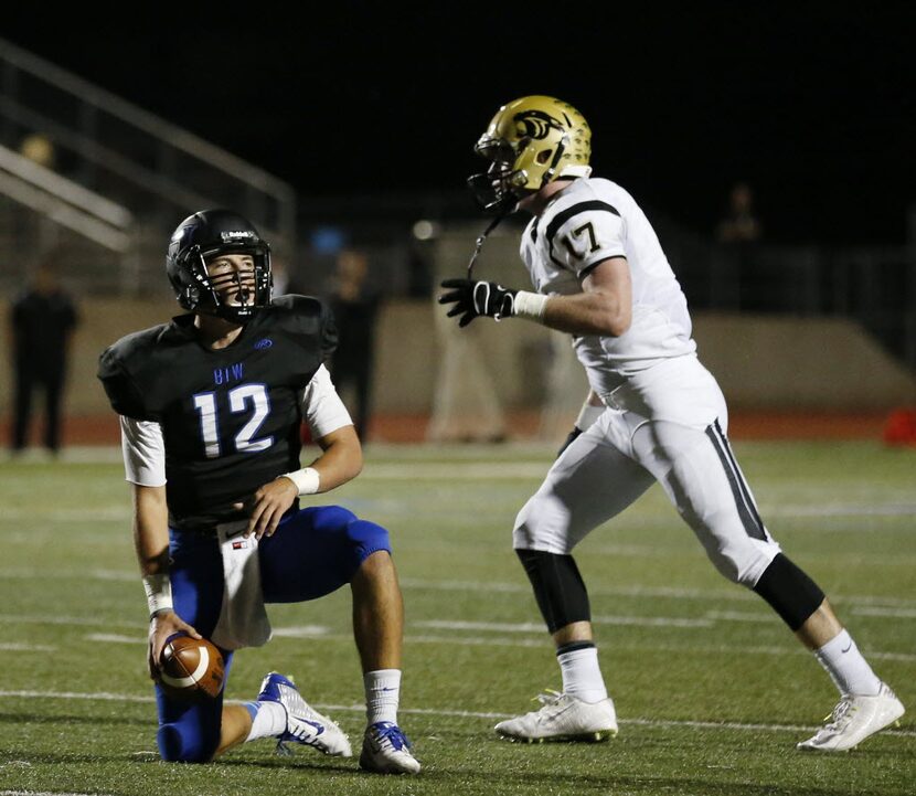 Hebron quarterback Clayton Tune (12) reacts after being sacked following the mishandling of...