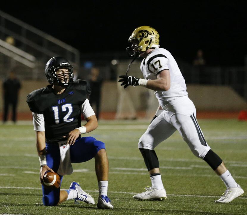 Hebron quarterback Clayton Tune (12) reacts after being sacked following the mishandling of...
