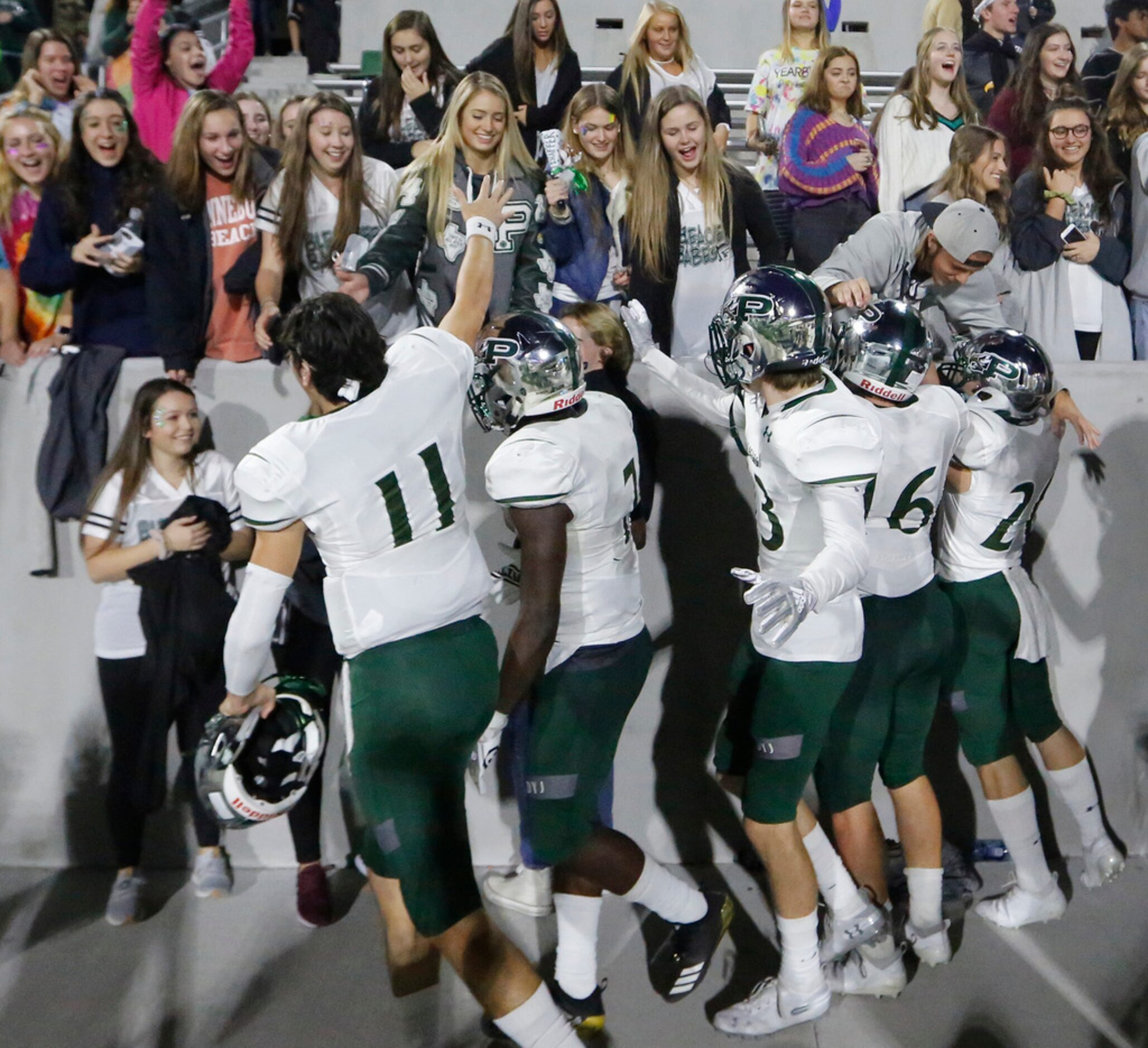 Prosper players celebrate with their fans after their 42-37 win during the Prosper High...