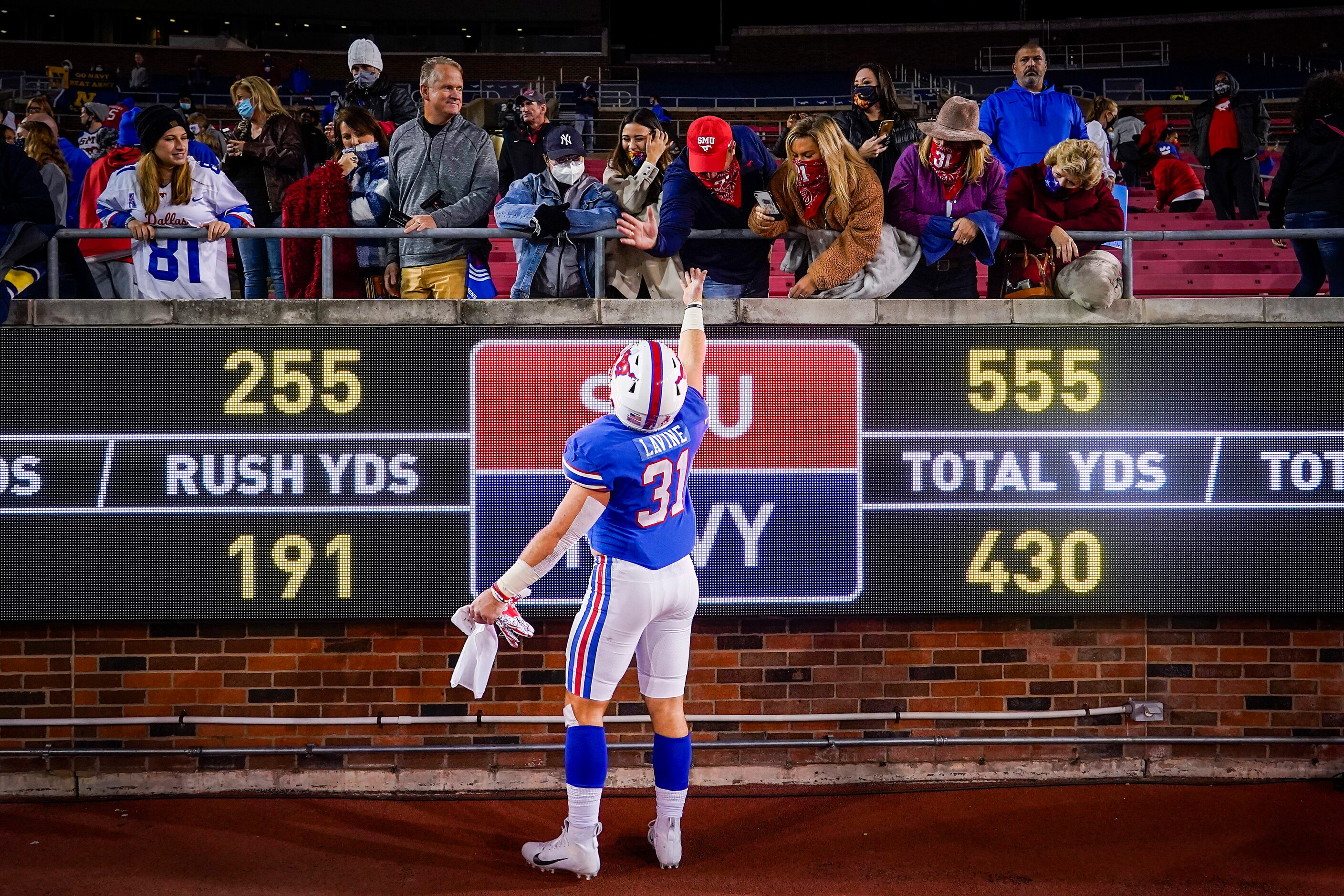 SMU running back Tyler Lavine celebrates with his family after a win over Navy in an NCAA...