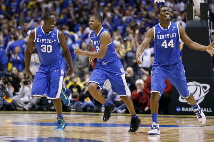 Kentucky Wildcats guard Aaron Harrison (2), center, reacts with teammates Kentucky Wildcats...