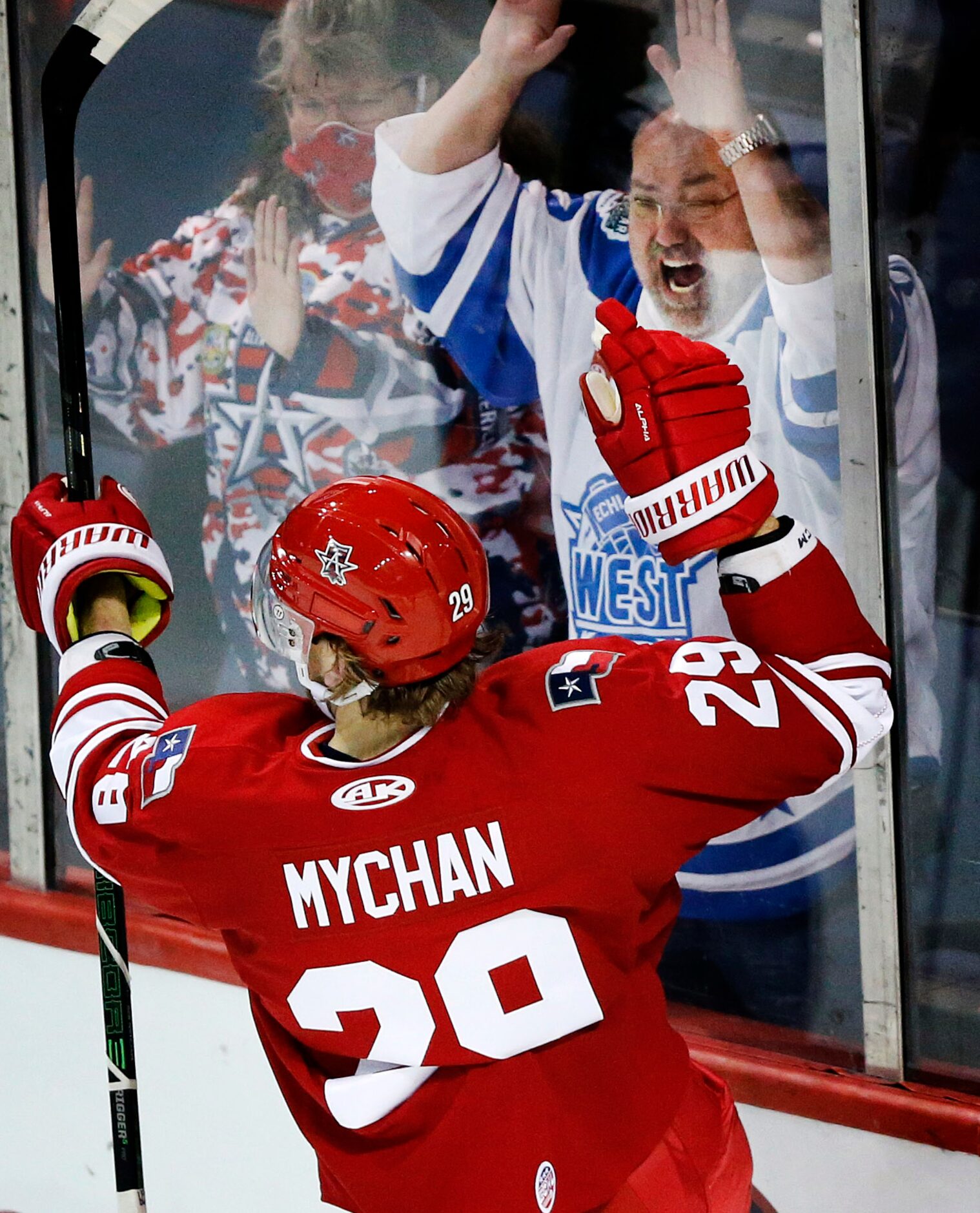 An Allen Americans hockey fan cheers Americans forward Jesse Mychan's first period goal...