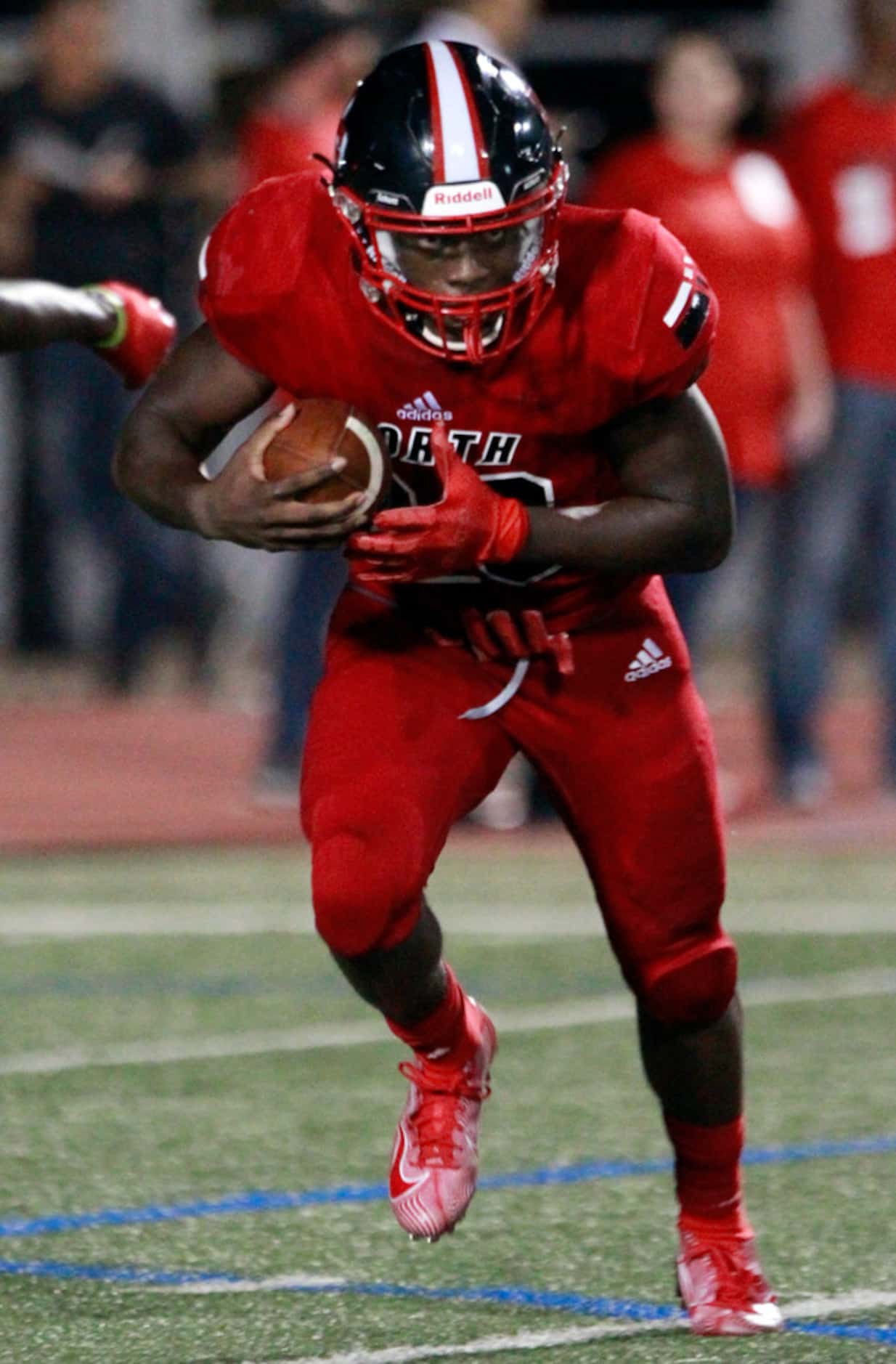 North Garland RB Sabron Woods (20) keeps his eyes on the prize, as he carries the football...