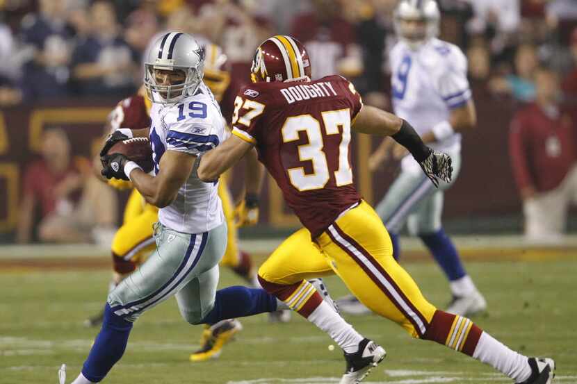 Dallas Cowboys wide receiver Miles Austin runs from Washington Redskins safety Reed Doughty...