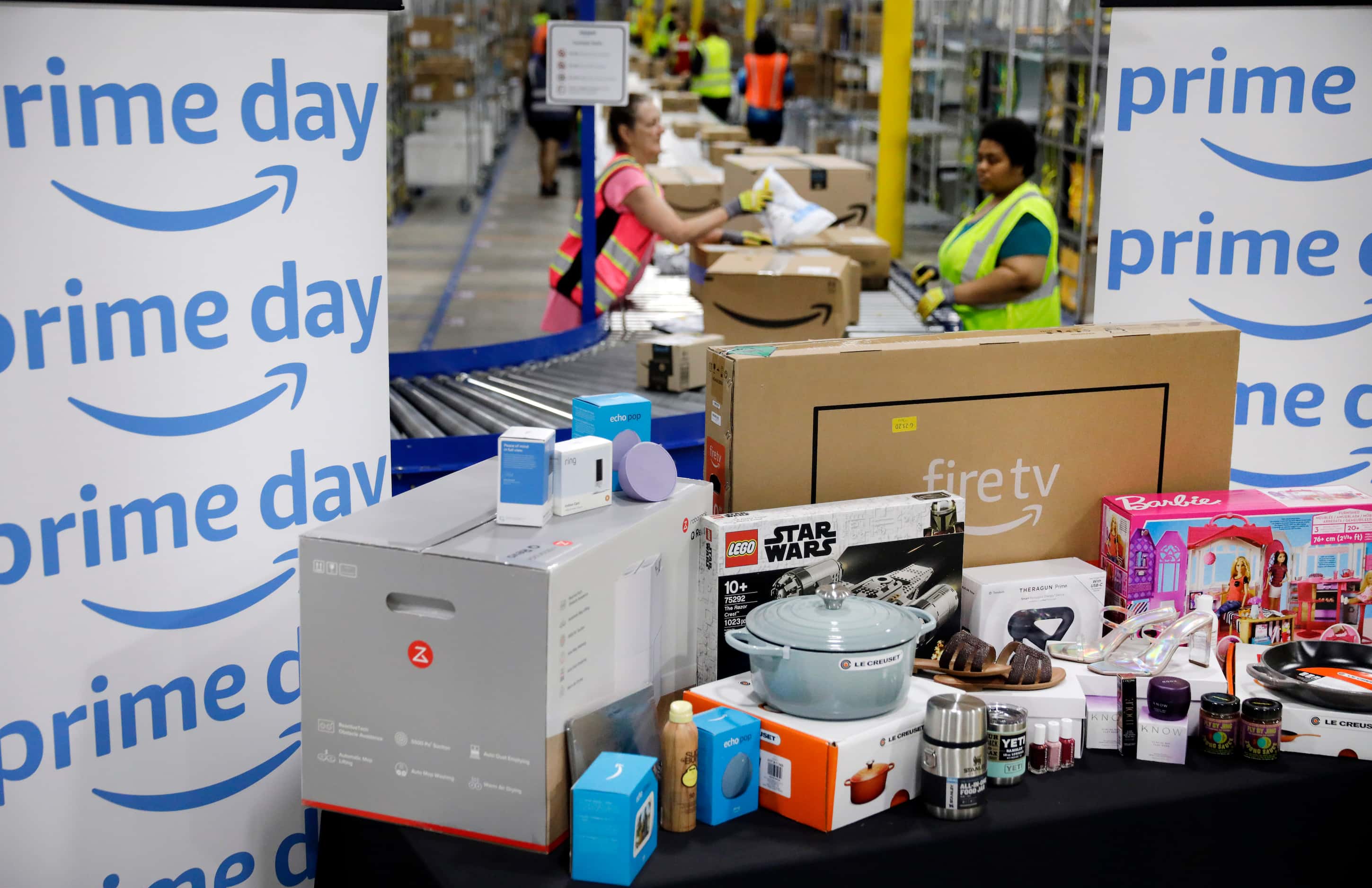 Crew members sort early PRIME day deals packages as they arrive at one of the country’s...