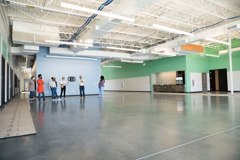 Austin Street's CEO, Daniel Roby (second from right), showed the nonprofit's new building to...