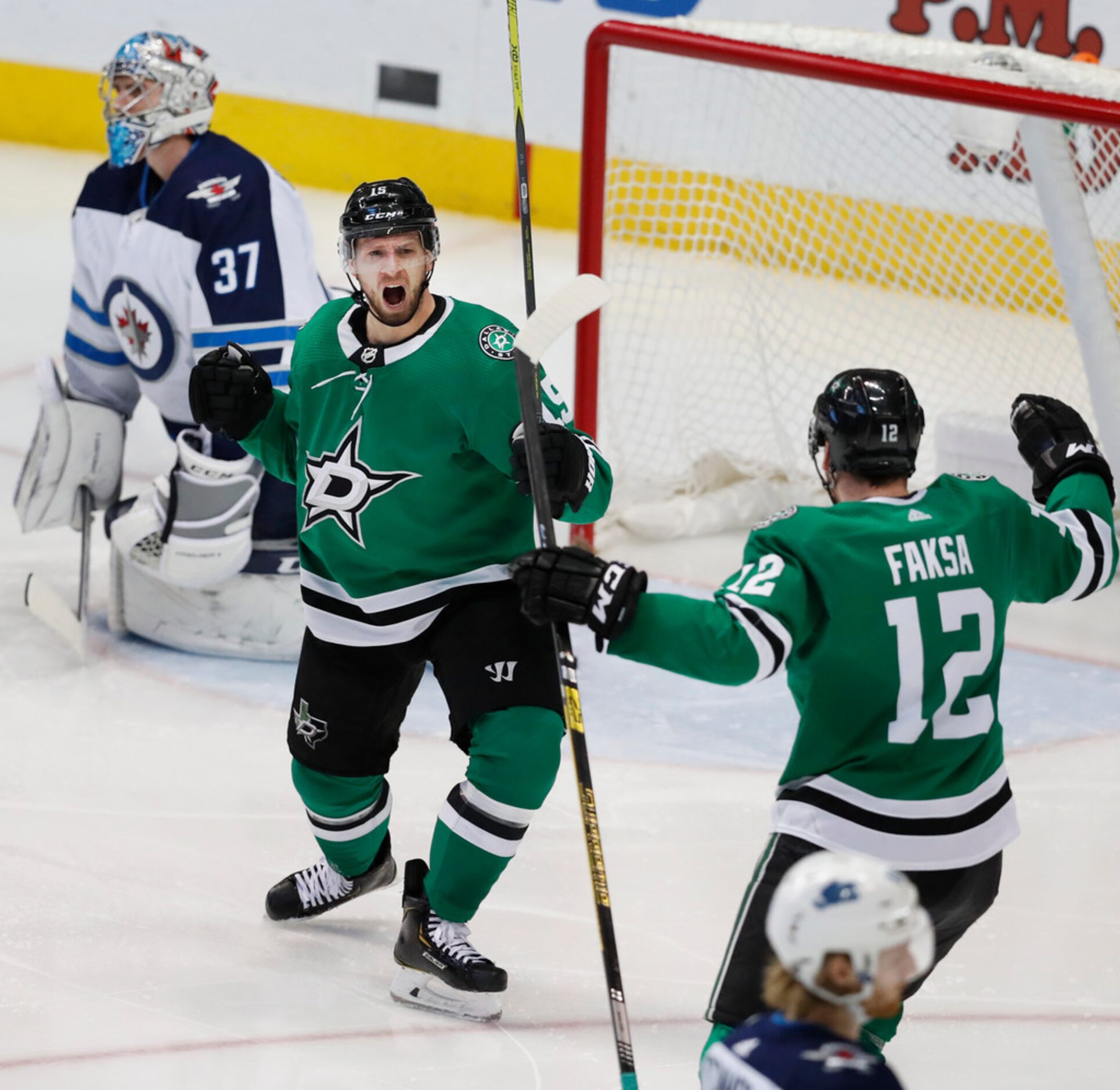 Dallas Stars left wing Blake Comeau (15) celebrates with teammate Radek Faksa (12) after...