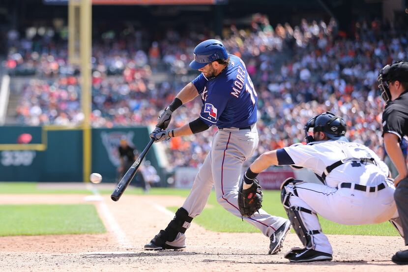 DETROIT, MI - MAY 25: Mitch Moreland #18 of the Texas Rangers singles to right field in the...