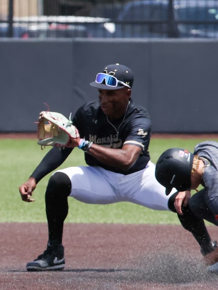 Rockwall junior Pearson Riebock (10) slides safely into second base just short of a catch by...