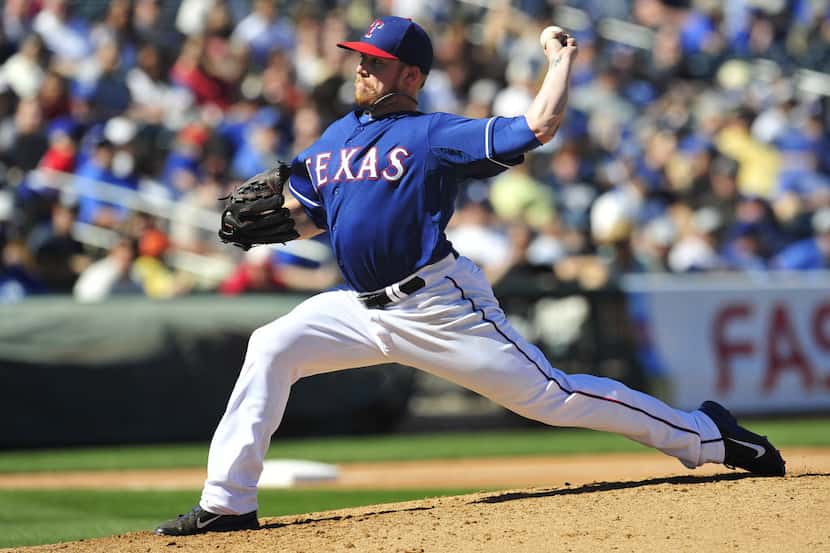March 8, 2014; Surprise, AZ, USA; Texas Rangers relief pitcher Robbie Ross (46) pitches the...