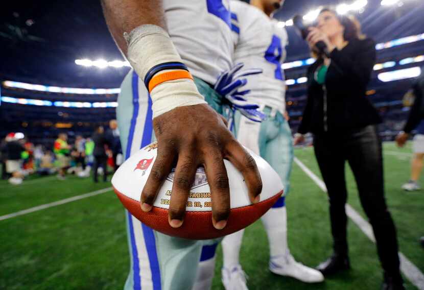 Dallas Cowboys running back Ezekiel Elliott holds the Sunday Night Football game ball tight...