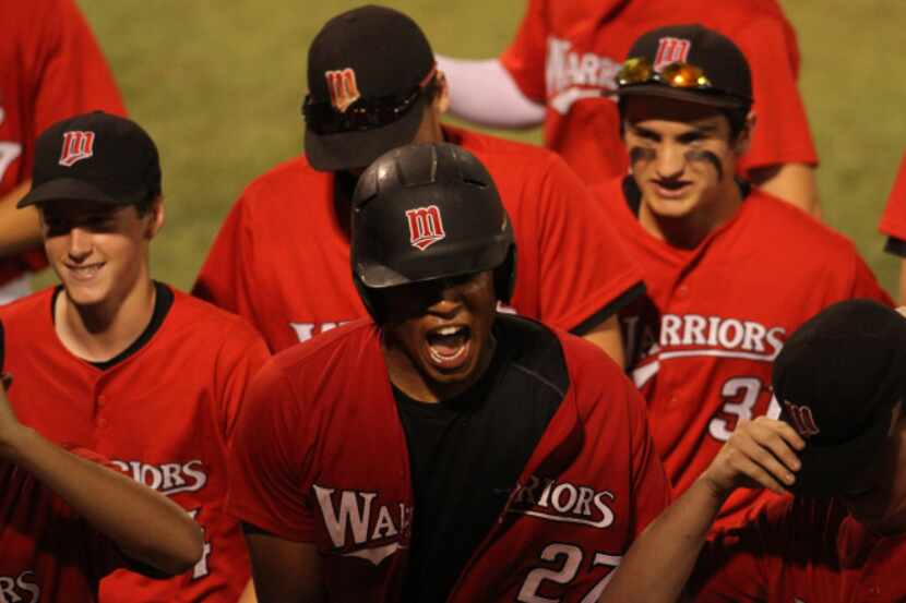 Arlington Martin outfielder Anthony Lyons (27) roars with excitement as he celebrates with...
