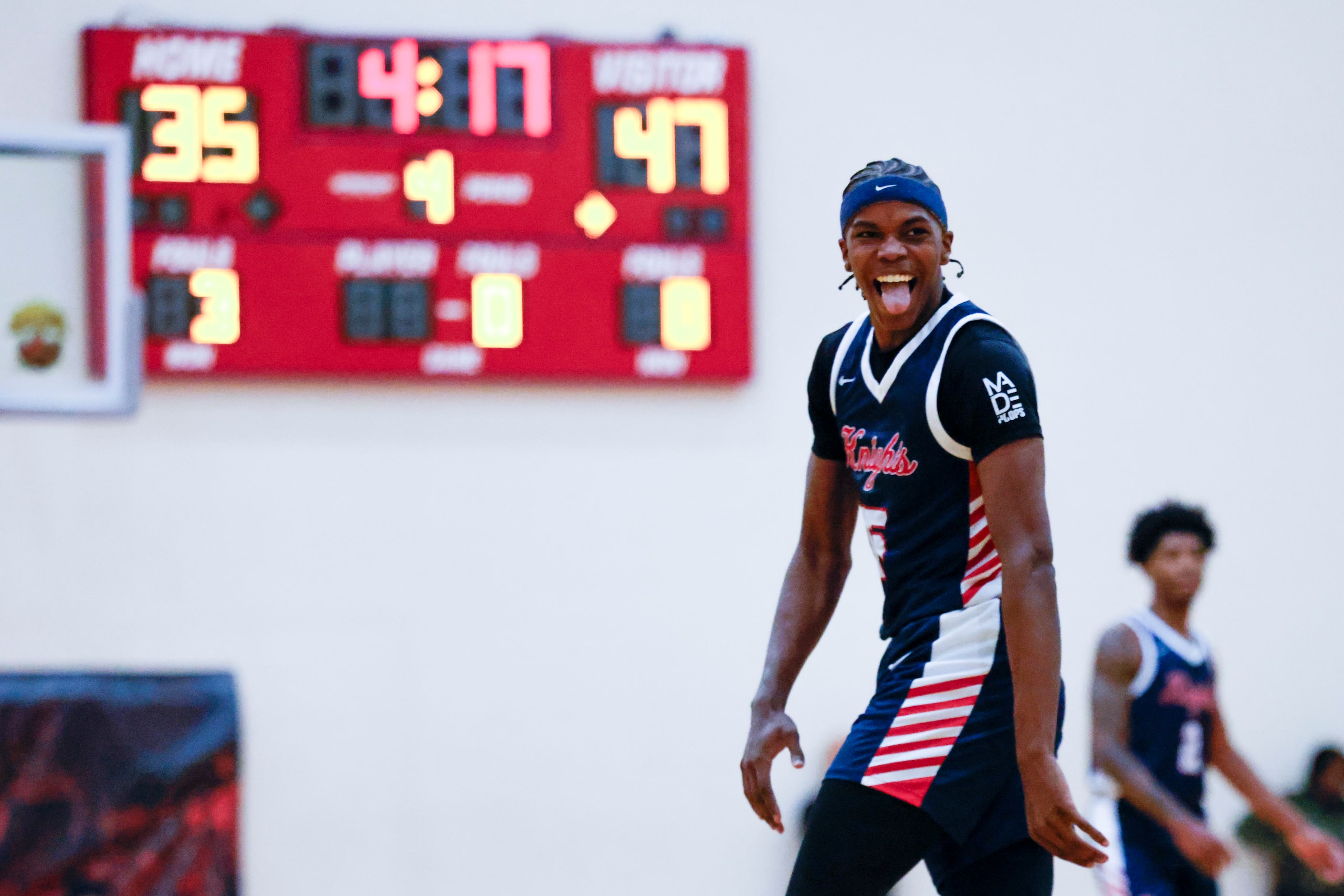 Kimball High’s Lance Carr celebrates following a dunk against Centennial High of California...