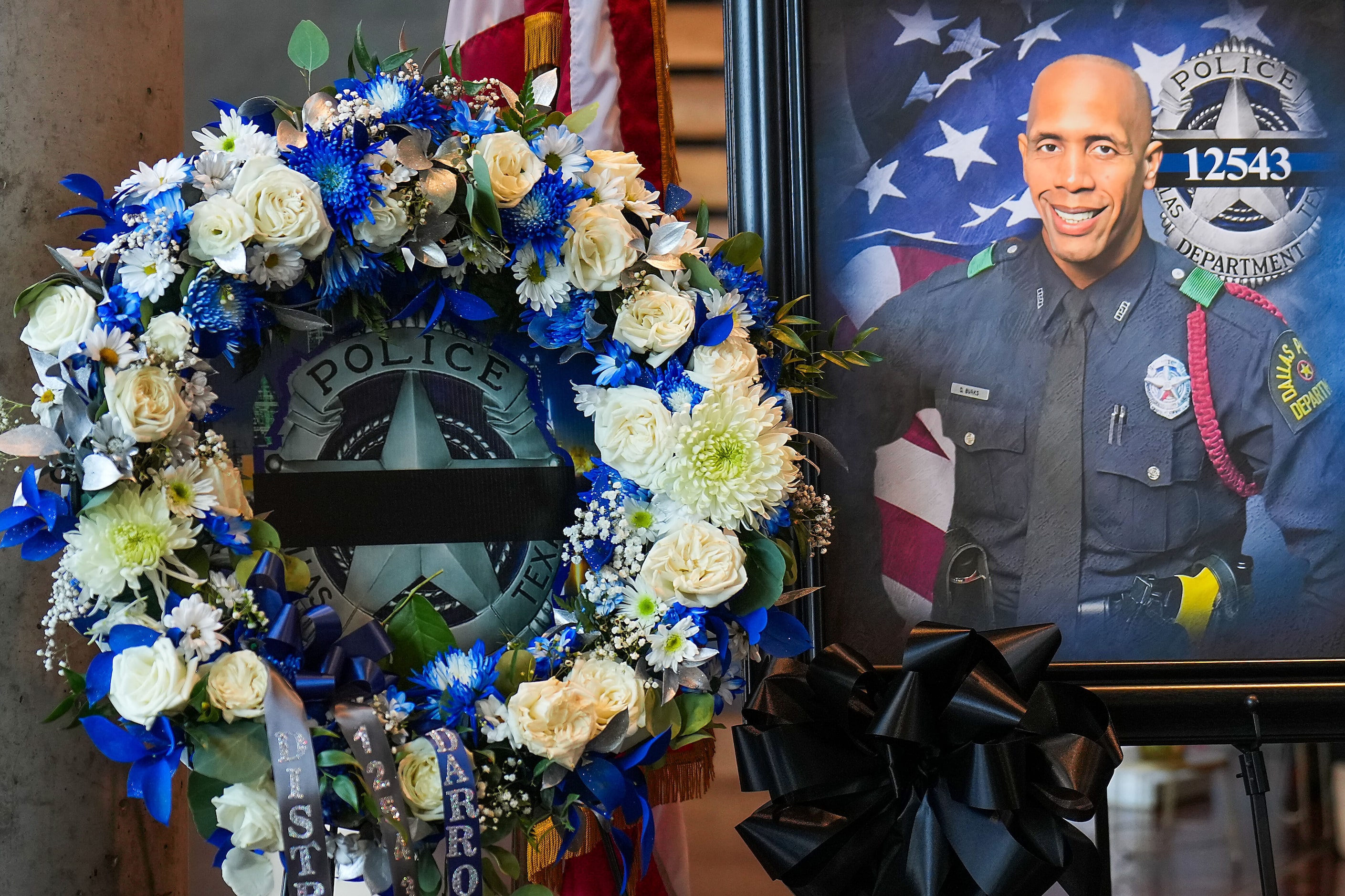 A wreath and a portrait of Dallas police officer Darron Burks are seen before funeral...