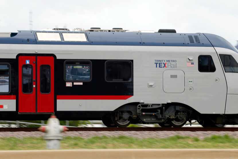 A pair of Trinity Metro TEXRail commuter trains pass one another in Grapevine, The actions...