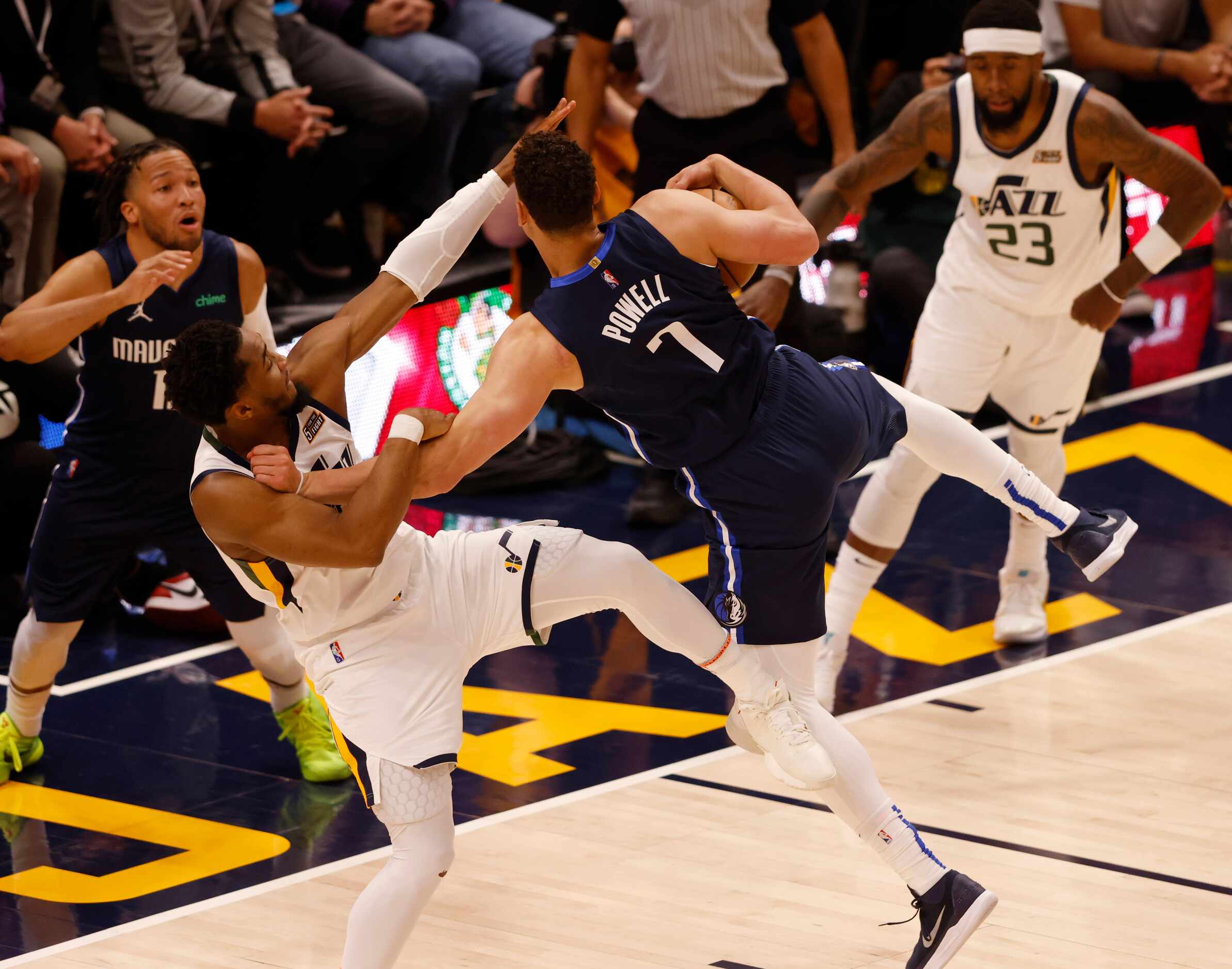 Dallas Mavericks center Dwight Powell (7) is fouled by Utah Jazz guard Donovan Mitchell (45)...