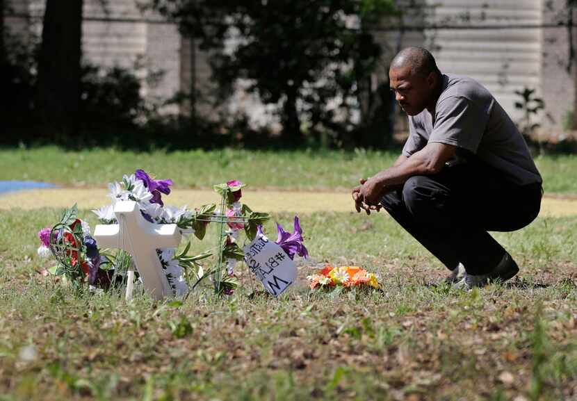 Terence Wright, of North Charleston, S.C., pays his respects at the scene where Walter Scott...