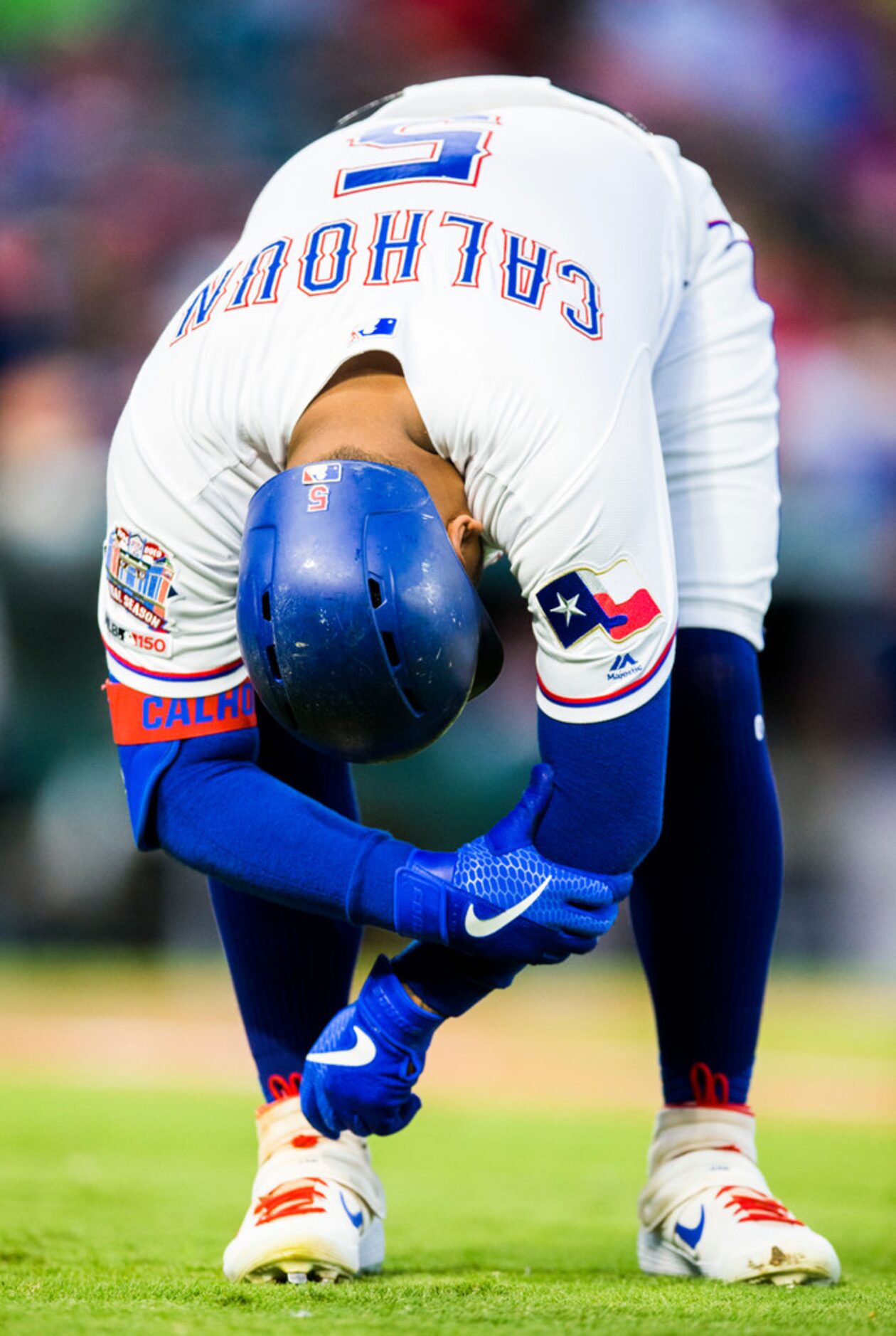 Texas Rangers designated hitter Willie Calhoun (5) reacts to getting hit by a pitch from...