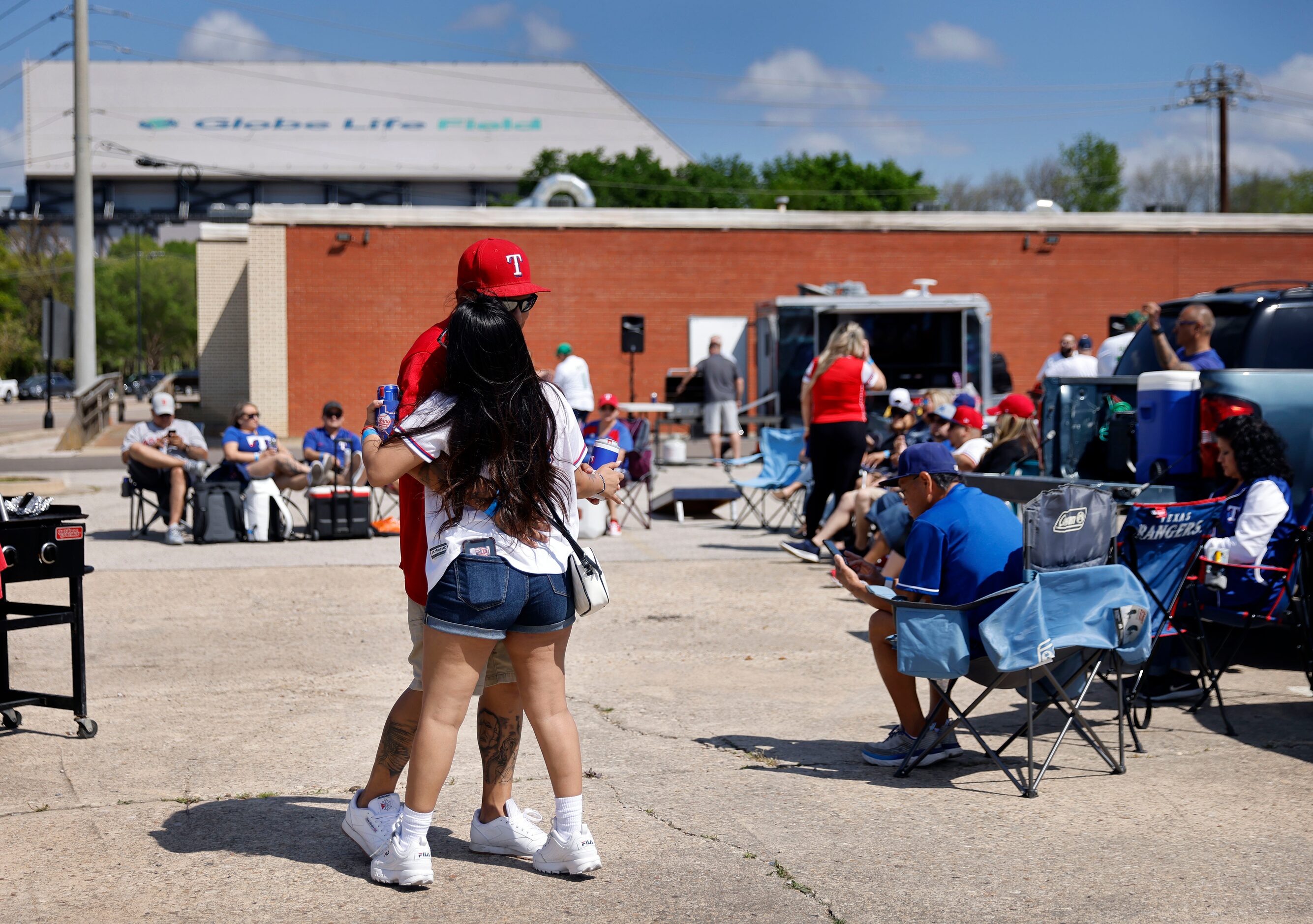 Texas Rangers fans Angela Zurita and her boyfriend Pedro Martinez danced to country music...