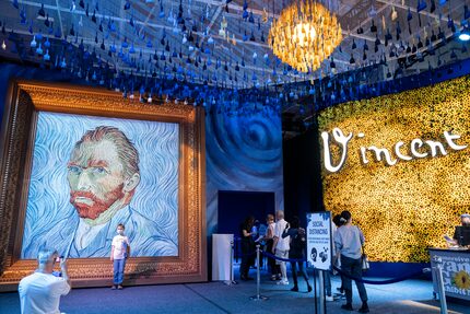 At the New York show, guests arrive beside a giant replica of celebrated painter Vincent Van...