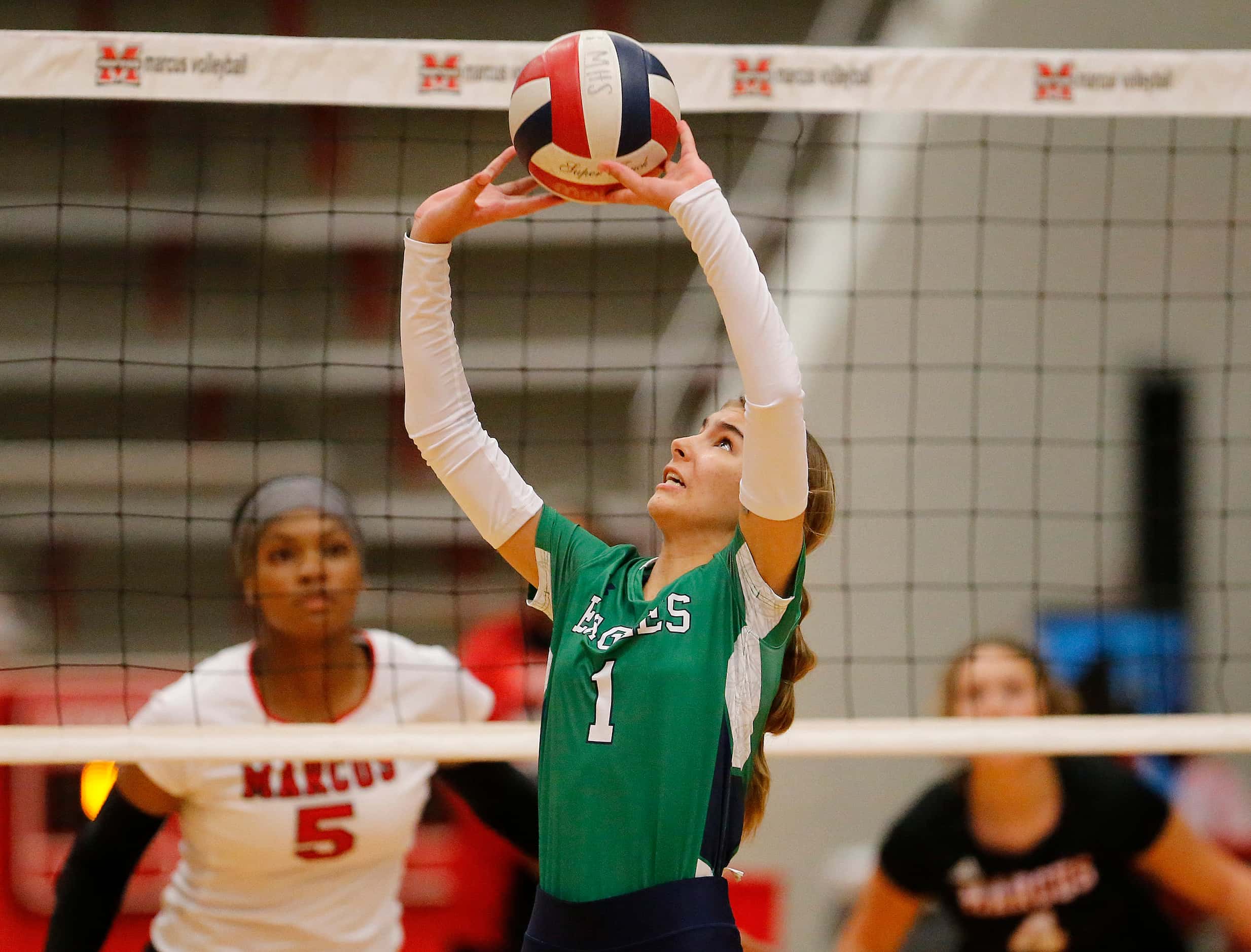 Eaton setter Keely Shearer (1) makes a set in game one as Flower Mound Marcus High School...
