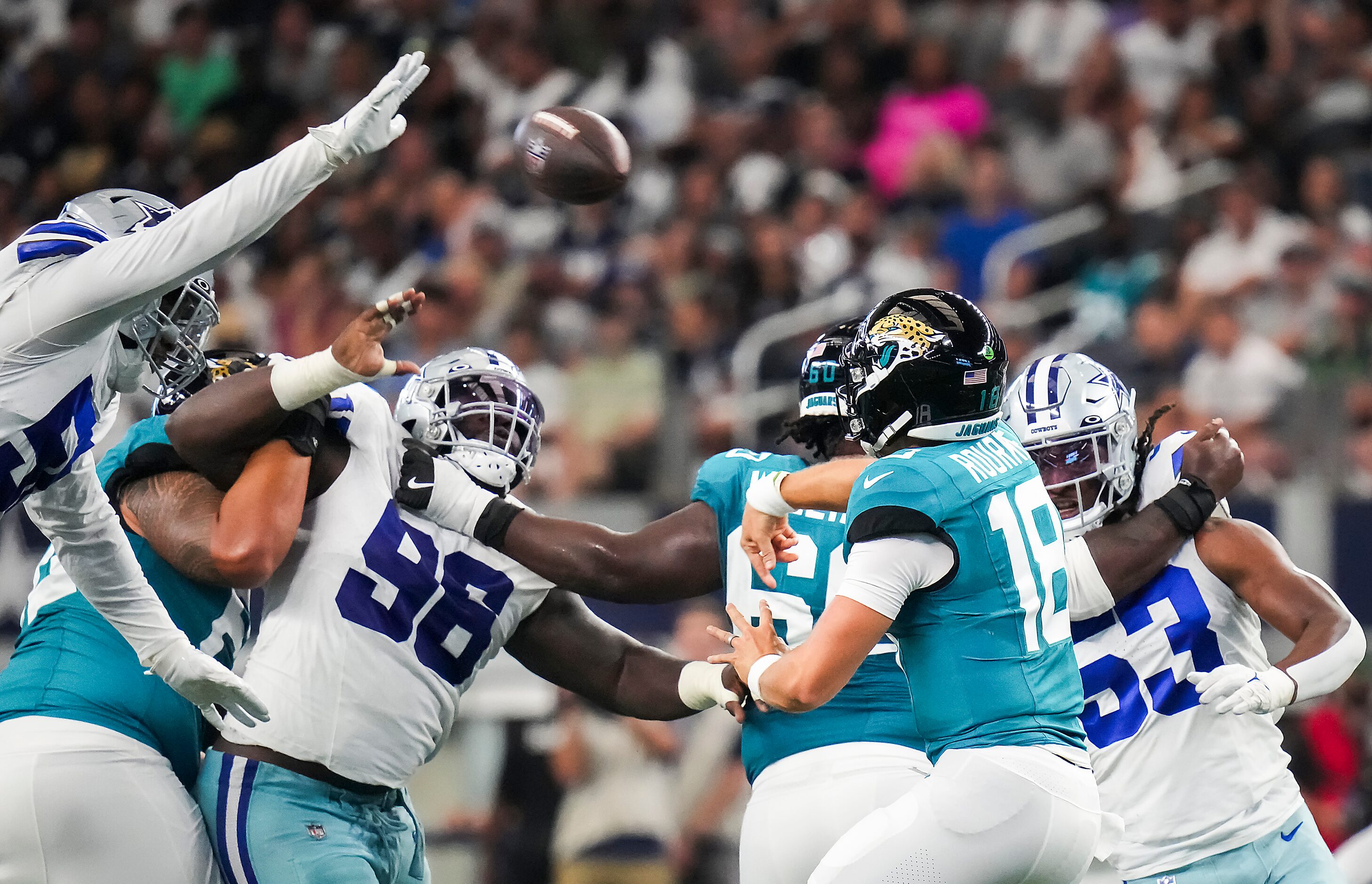 Jacksonville Jaguars quarterback Nathan Rourke (18) gets off a pass under pressure from...