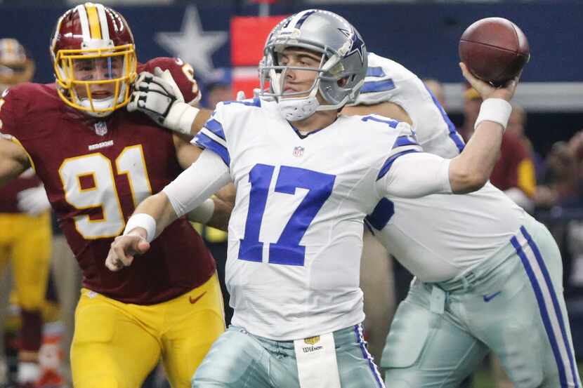 Dallas Cowboys quarterback Kellen Moore (17) throws a first-half pass under pressure from...
