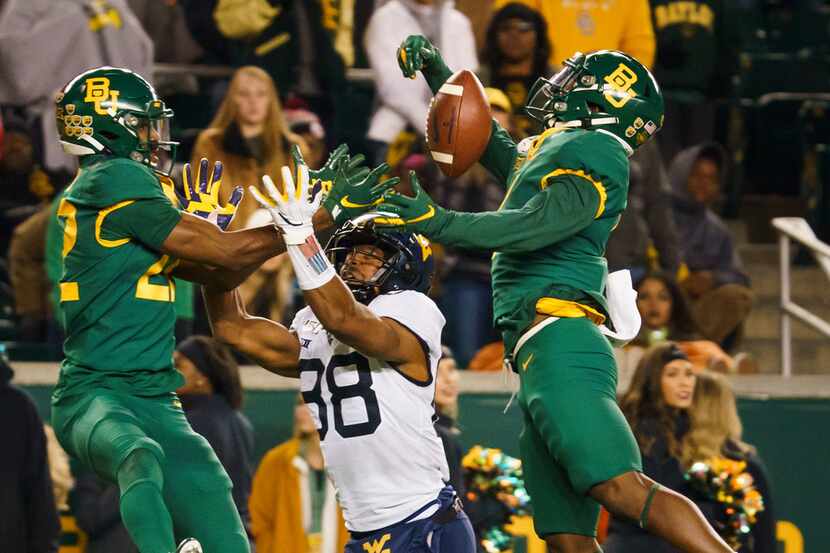 Baylor cornerback Grayland Arnold (1) breaks up a pass intended for West Virginia wide...
