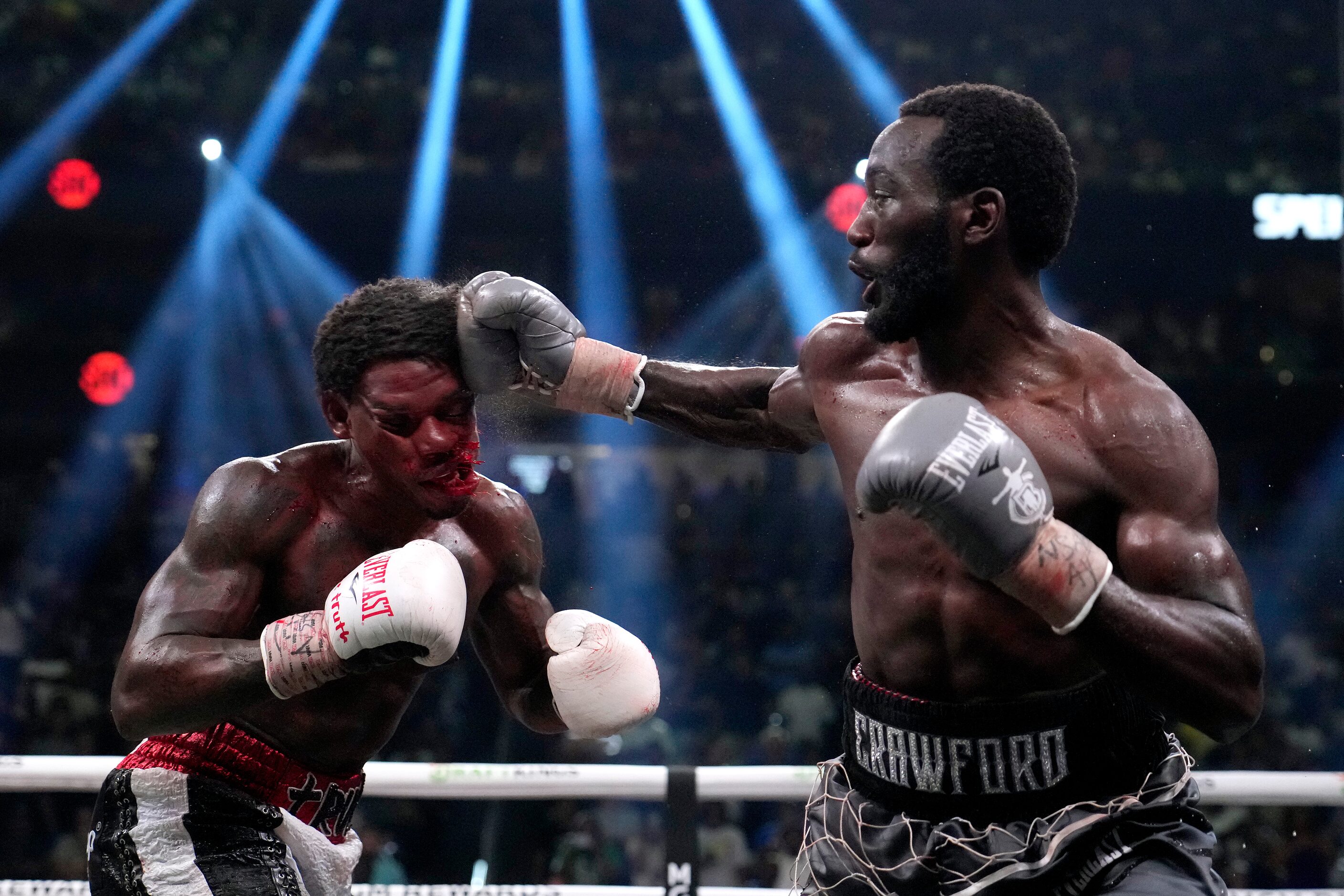 Terence Crawford, right, hits Errol Spence Jr. during their undisputed welterweight...